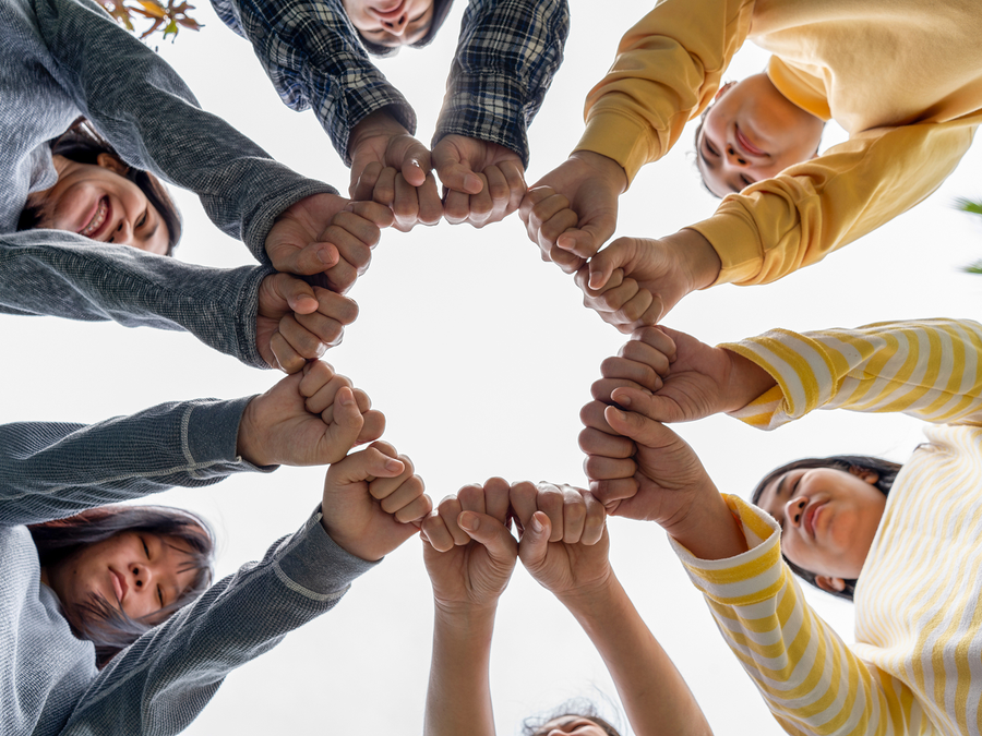 Diverse hands touching in a circle showing unity