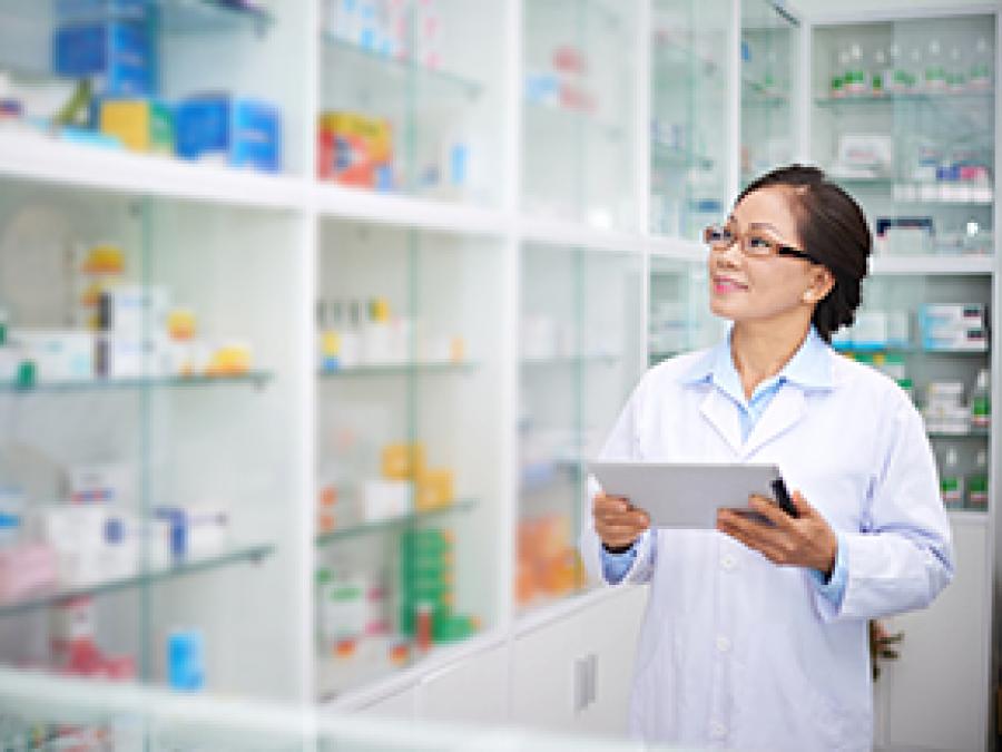 Pharmacist checking the medicine shelf