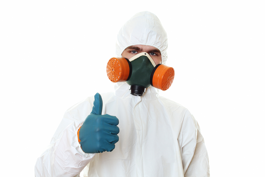 Person in complete bunnysuit with respirator and gloves