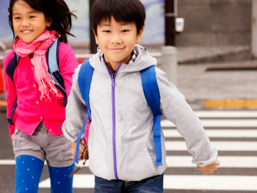 boy and girl crossing the street