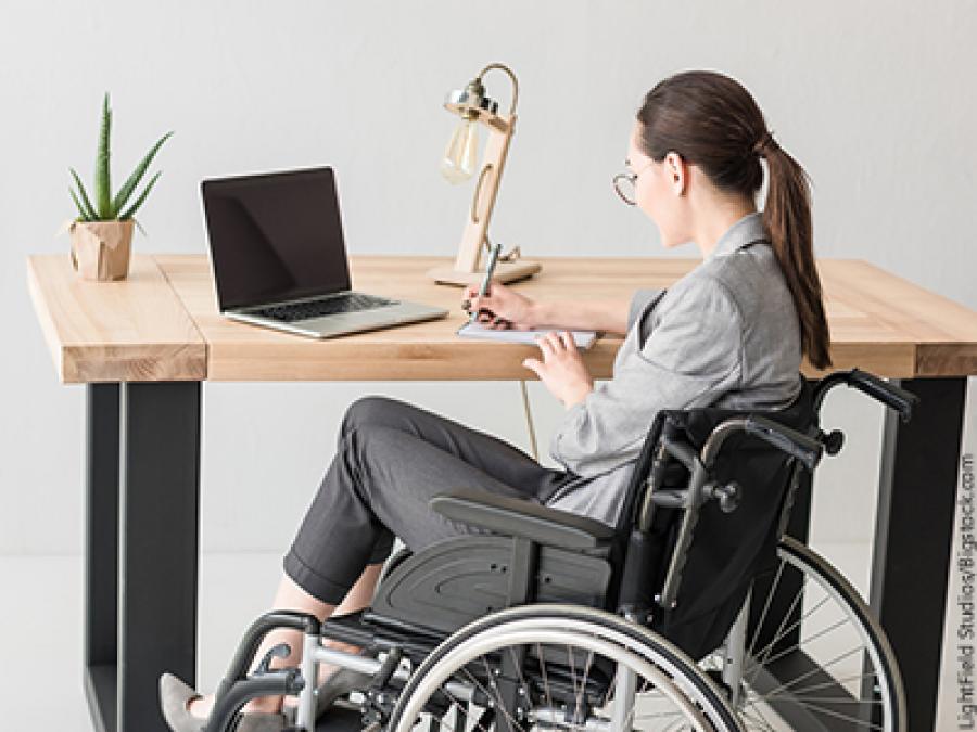 Lady sitting on her wheel chair while working