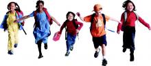Happy kids with their backpacks running